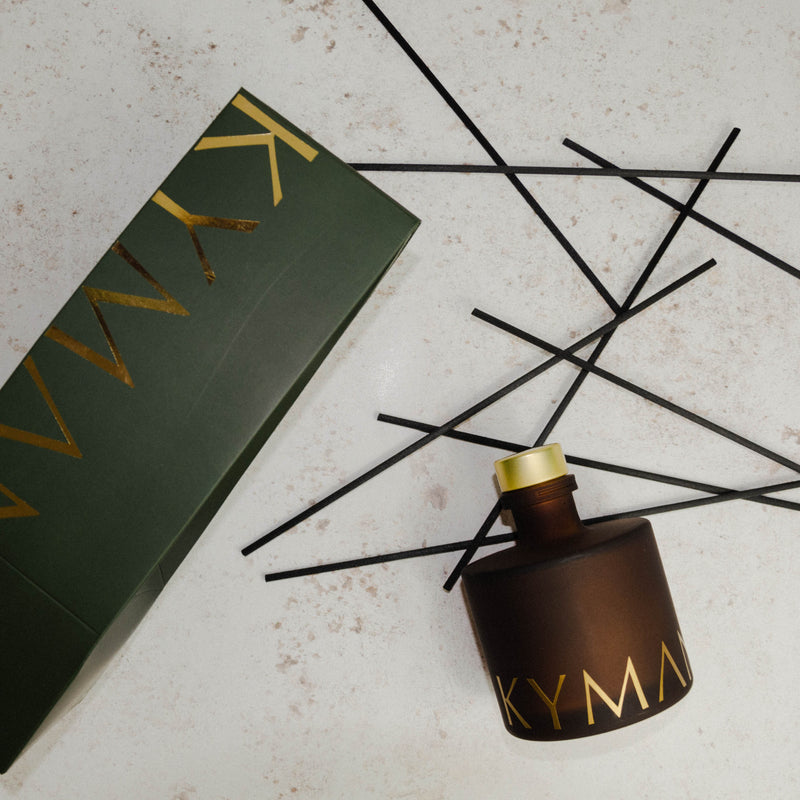 Luxury reed diffuser, scattered reeds and packaging by Kymani